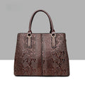 Leather snake-pattern handbag